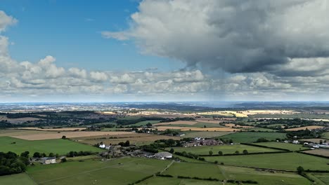 typical yorkshire village scene with blue sky's clouds and open farmland. emley moor huddersfield. shot with a drone