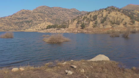 Sideway-camera-movement-to-the-right-over-a-California-Water-reservoir-in-the-mountains