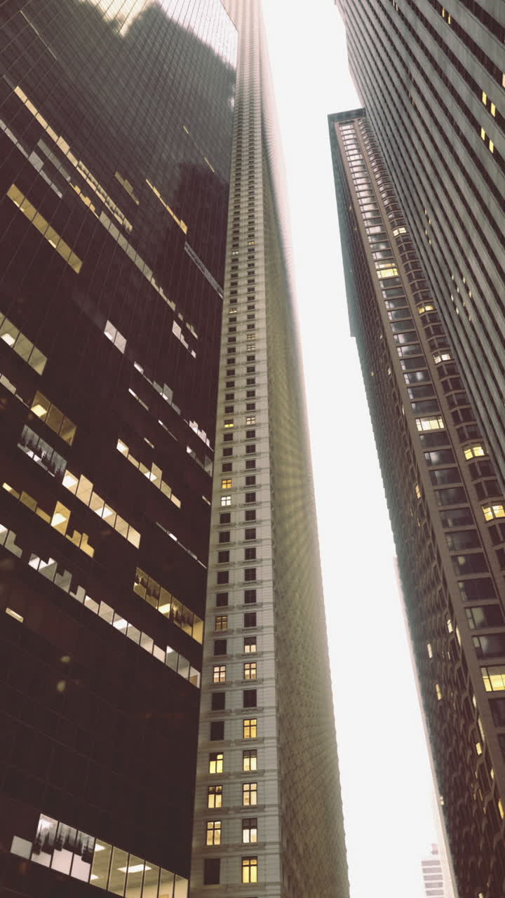 Skyscrapers tower above in urban setting during early evening light