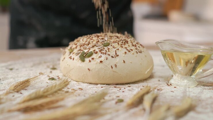 Sprinkling Healthy Seeds onto Raw Bread Dough