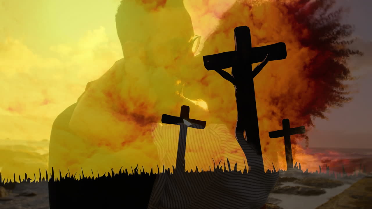 Dramatic orange and yellow sky with silhouettes of three crosses in foreground