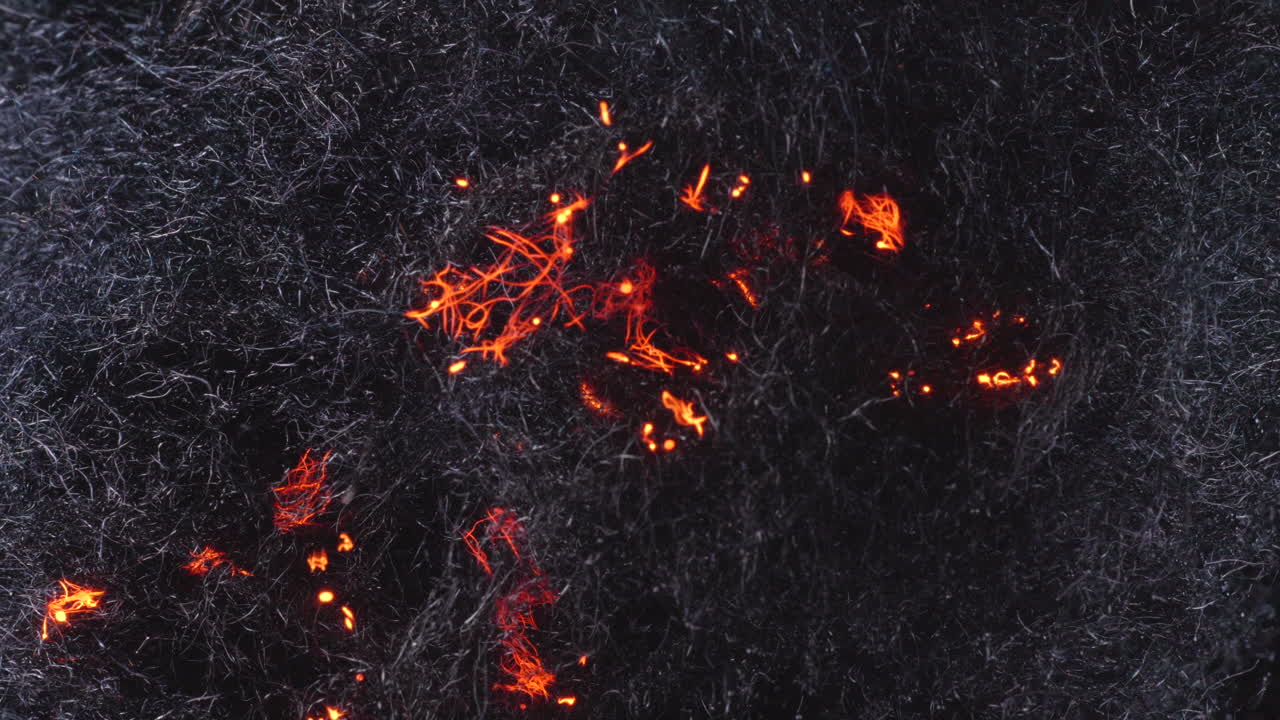 Glowing Embers Fade To Black Behind Steel Wool In Fire