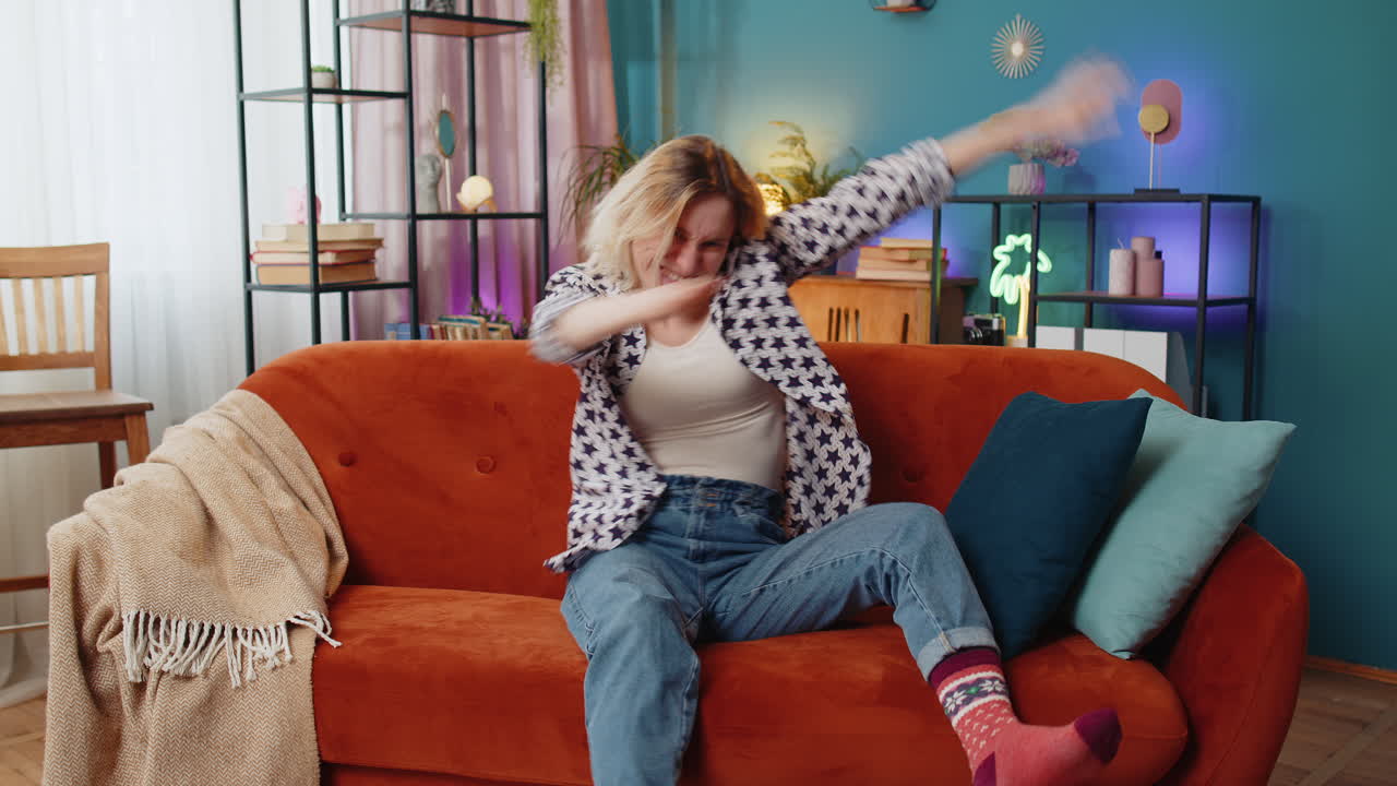 Trendy cheerful positive woman having fun dancing dabbing raising hands making dub winner dance