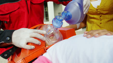 paramedic giving oxygen to injured girl