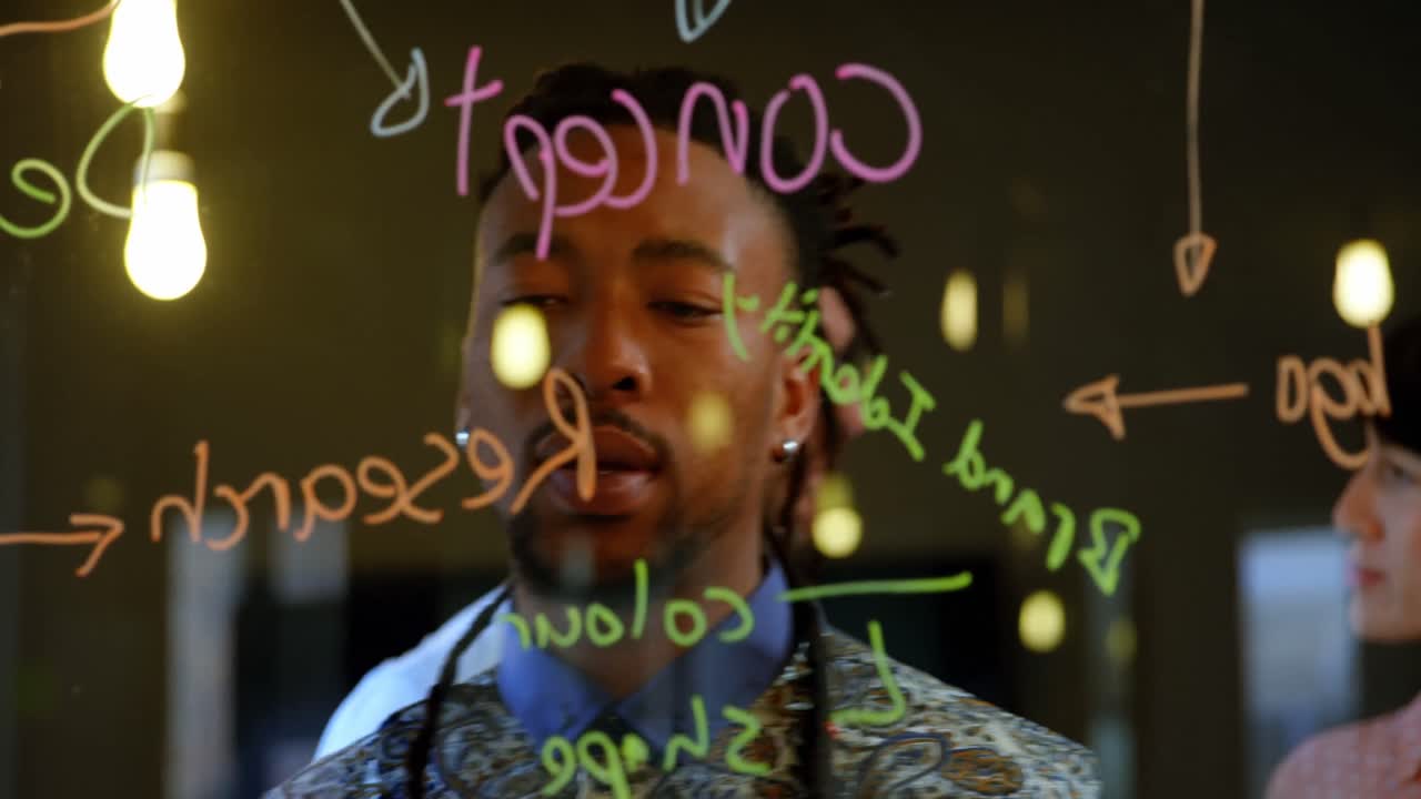 Male executive working on glass wall in office 4k