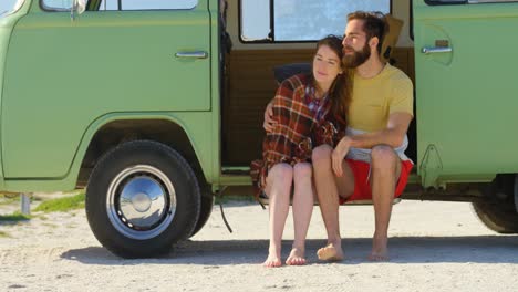 young couple sitting van on a sunny day 4k