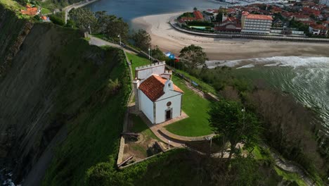 spectacular views of the hermitage of la guia dominating the entrance to the cove of the mythical port of ribadesella in asturias