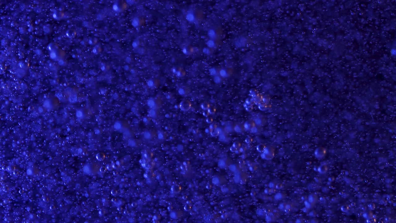 무한 배경에 대해 깊고 어두운 혼합물에서 상승하는 깊고 푸른 거품 클러스터