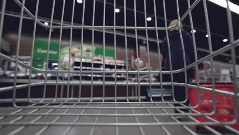 inside an empty shopping cart in a grocery store