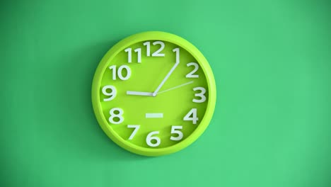 time lapse of green clock on green wall