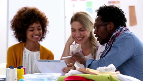 fashion designers working with a tablet pc