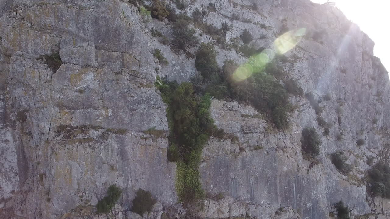 Pic Saint Loup close drone shot along a cliff discovering a valley. France