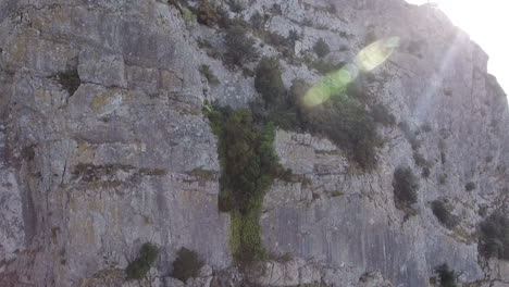 Pic-Saint-Loup-close-drone-shot-along-a-cliff-discovering-a-valley.-France