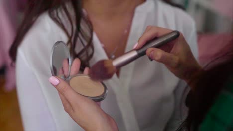 woman getting her makeup applied