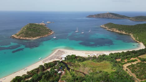 turquoise blue bay with sandy tuerredda beach, boats and islands in teulada, sardinia, italy - 4k aerial circling