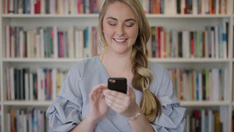 portrait-attractive-blonde-woman-entrepreneur-using-smartphone-enjoying-browsing-online-social-media-messages-young-female-student-sending-sms-in-library-bookstore-slow-motion