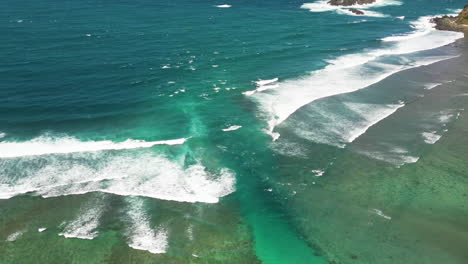 Hyperlapse-Flug-über-Sich-Bewegende-Wellen-Mit-Kanal-Auf-Lombok-An-Einem-Sonnigen-Tag-–-Flug-Von-Oben-Nach-Unten