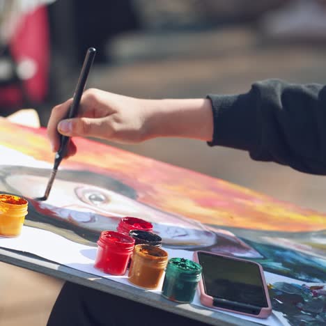 artist working on painting outside