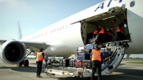 baggage handling: efficiently loading and unloading luggage from an airliner with ground crew at the airport