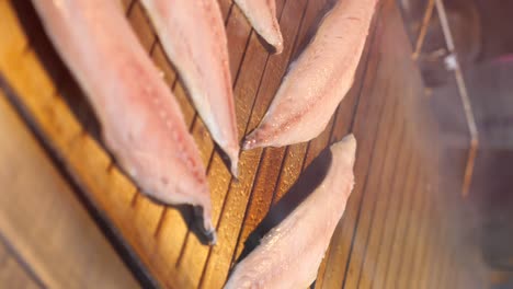 raw fish fillets on a wooden board
