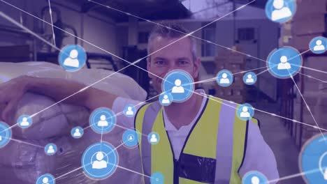 Animation-of-network-of-profile-icons-against-caucasian-male-worker-smiling-at-warehouse