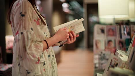 woman reading a book in a bookstore