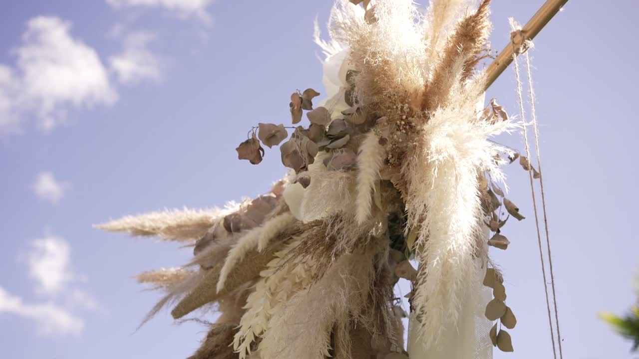 Elegant dried floral arrangement with soft pampas grass under a clear blue sky