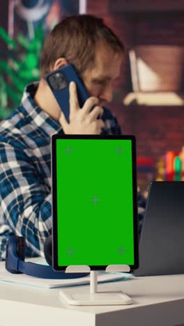 vertical video isolated screen device next to freelancer receiving telephone call