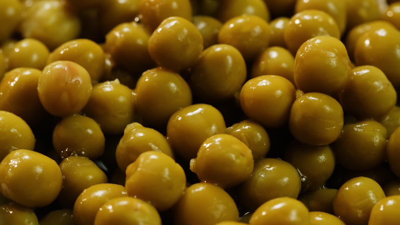 marinated pickled sweet green peas, rotation in circle. Take canned green pea kernels with a fork. High quality 4k footage