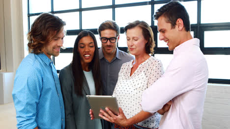 Businesspeople-interacting-while-using-digital-tablet