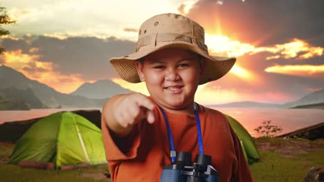 smiling boy camping at sunrise