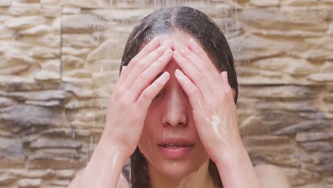 biracial woman relaxing and taking shower in bathroom