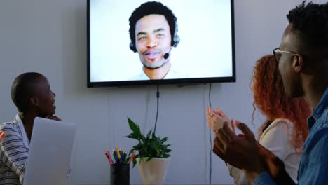 Side-view-of-young-mixed-race-business-team-planning-and-making-video-conference-call-in-office-4k