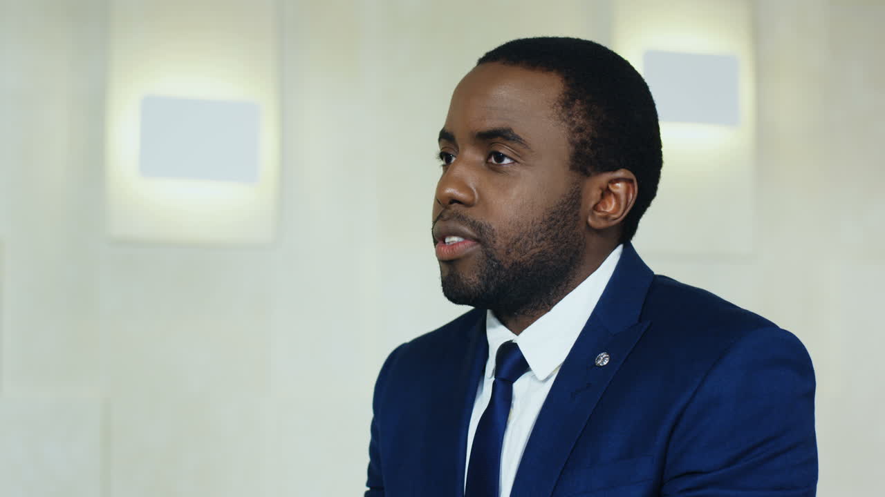 Close-up view of African American businessman talking and explaining something at a conference