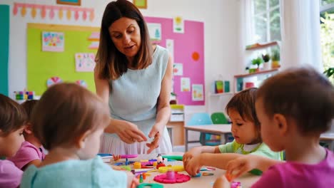 preschool children engaging in clay activity with teacher