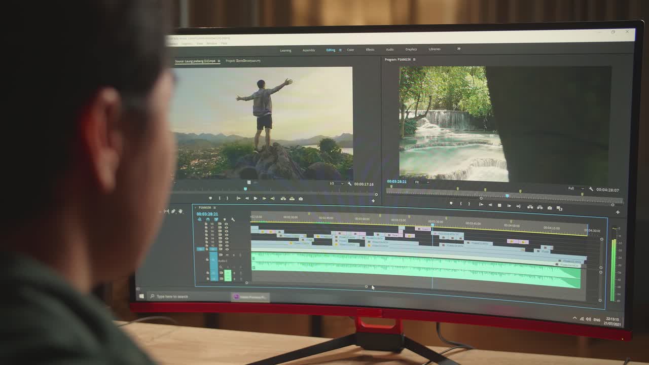 Asian Male Video Editor Works With Footage And Sound On His Personal Computer, He Works Late At Night