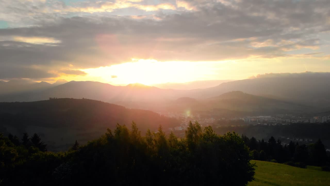 AERIAL beautiful young happy girl women running towards golden sunset over gorgeous mountain landscape