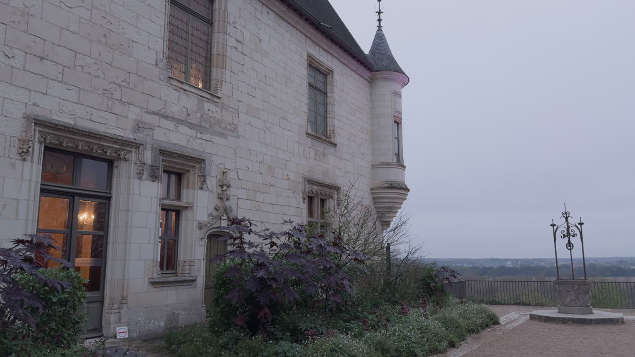 Tower and stone facade of Château de Chaumont castle in France, tilt down