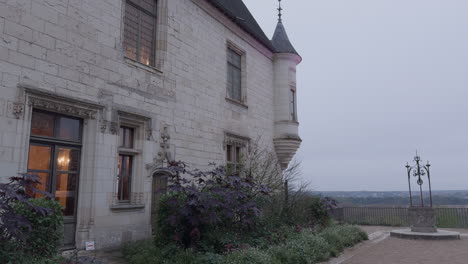 tower and stone facade of château de chaumont castle in france, tilt down