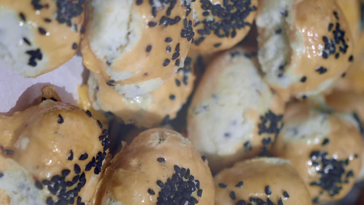 Close-up of small pastries with black sesame seeds
