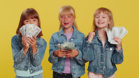 three girls siblings friends waving money dollar cash lottery game winner big income donation