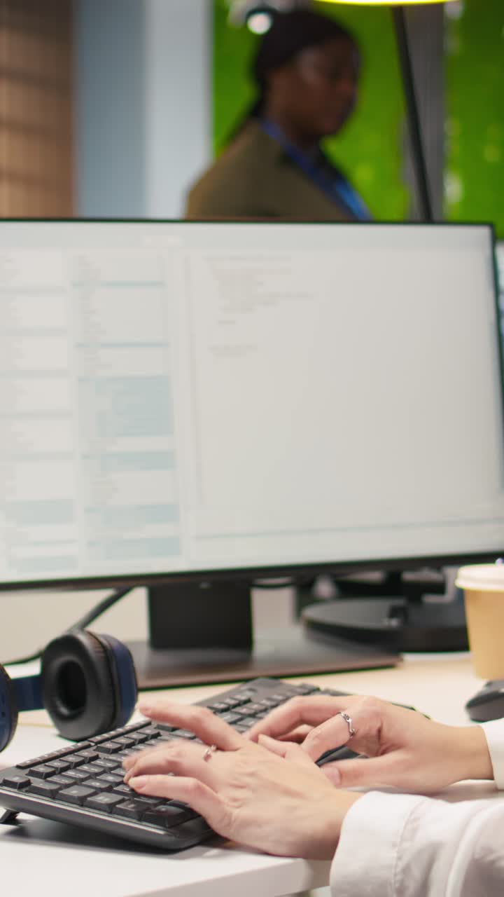 Vertical video Close up of IT expert coding with AI language model assistance in startup office