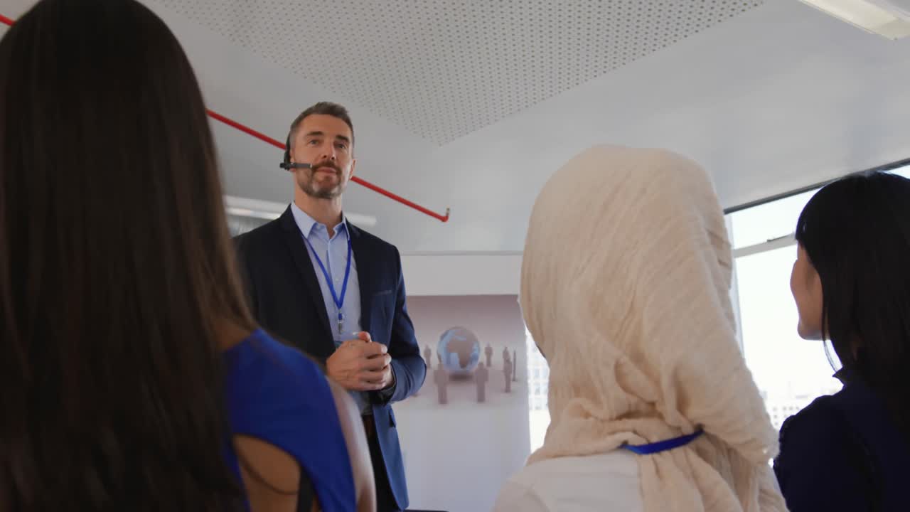 Male speaker with headset microphone addressing the audience at a business seminar