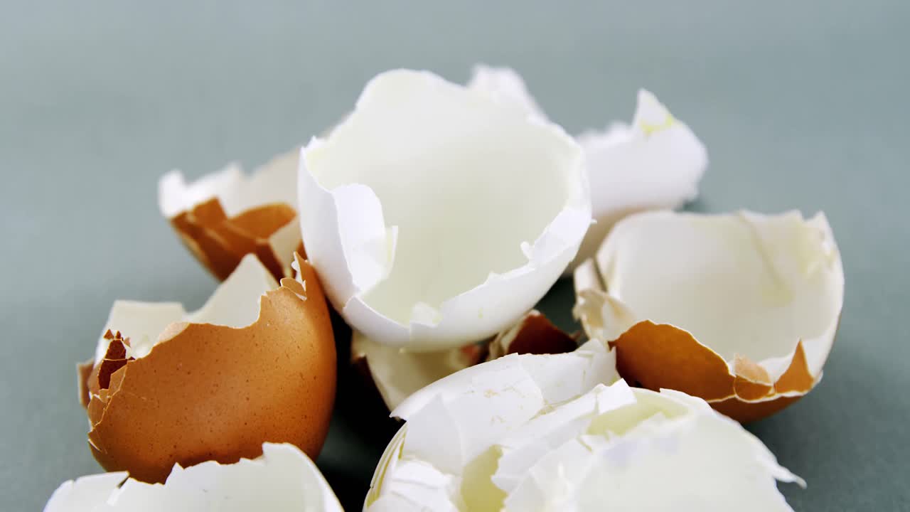 huevo marrón roto sobre un fondo gris