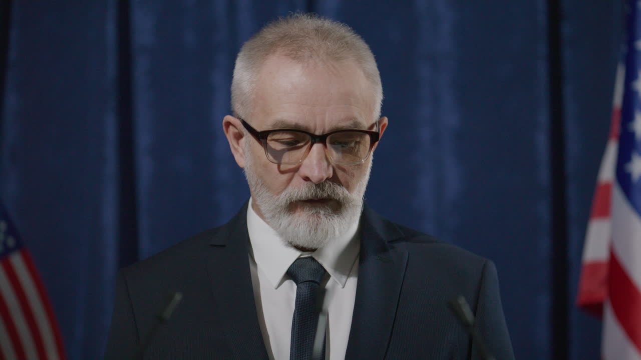 Senior Politician Delivering Speech at Press Conference