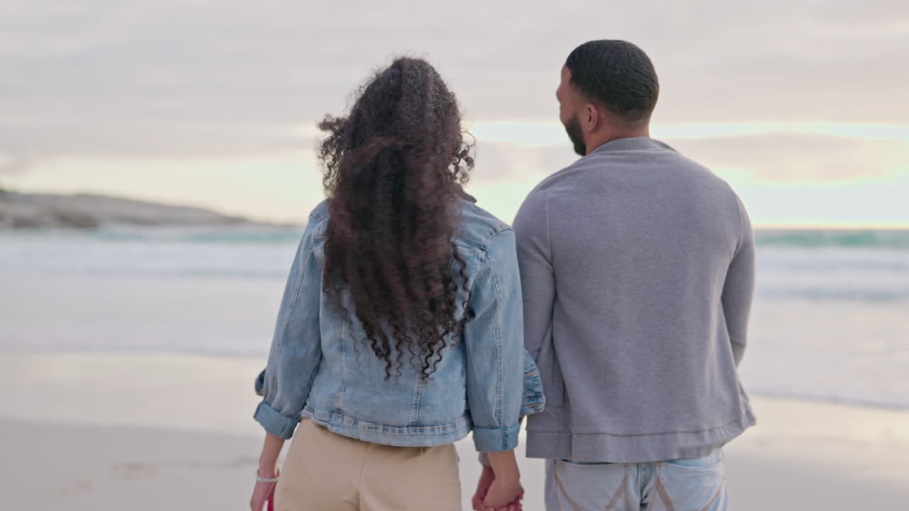 Couple, holding hands and walking at the beach