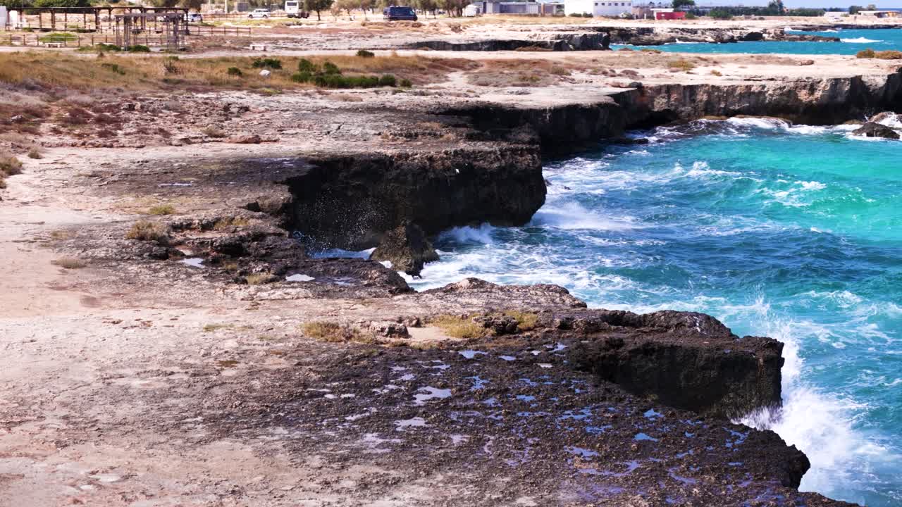 Tropical shore with rought sea, low angle motion view
