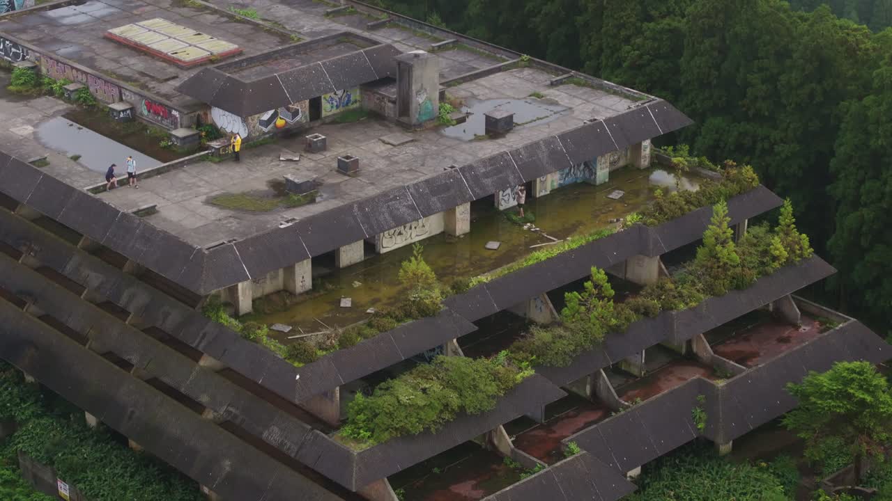 Aerial view of smooth abandoned Monte Palace hotel in Sete Cidades, Azores, capturing in the A from a fresh drone angle