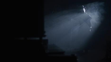 mysterious figure under spotlight