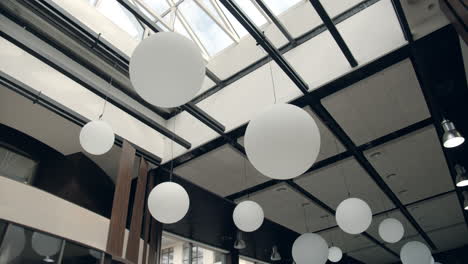 Hotel-luxury-interior-design.-Modern-chandelier-hanging-from-glass-ceiling.